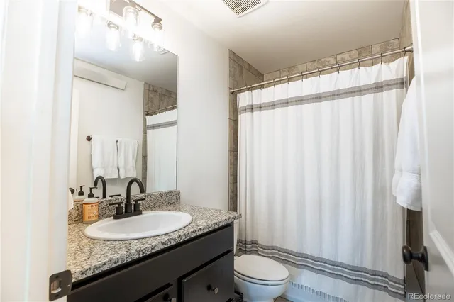 a spacious bedroom with a bed and a couch