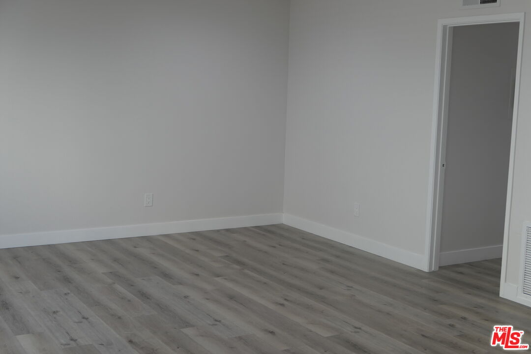 10836 Camarillo Street, Unit 3 North Hollywood, CA 91602 - Photo 12 of 12 a view of an empty room with wooden floor