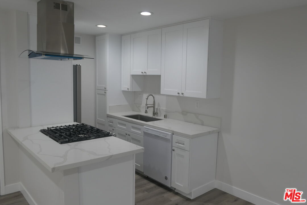 10836 Camarillo Street, Unit 3 North Hollywood, CA 91602 - Photo 5 of 12 a kitchen with a sink a stove cabinets and a refrigerator