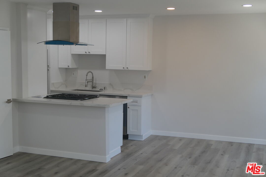 10836 Camarillo Street, Unit 3 North Hollywood, CA 91602 - Photo 6 of 12 a kitchen with a sink cabinets and appliances