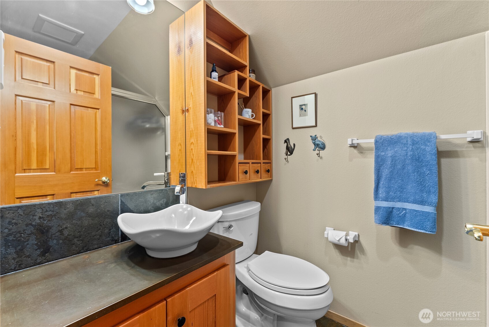 13 Serviceberry Road Winthrop, WA 98862 - Photo 25 of 40 a bathroom with a granite countertop sink and a mirror