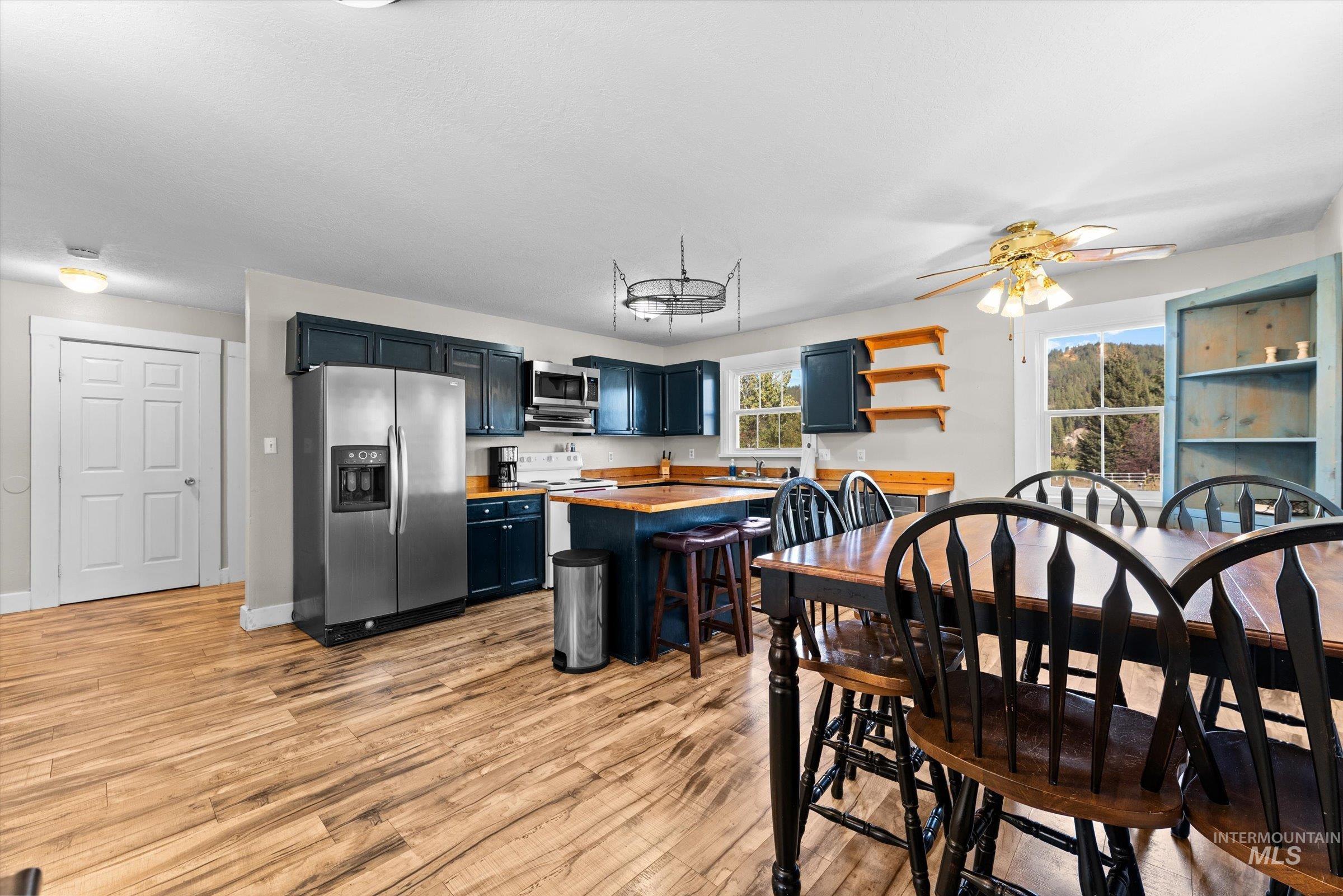315 South Middlefork Road Garden Valley, ID 83622 - Photo 19 of 49 Kitchen with stainless steel appliances, butcher block counters, a breakfast bar, blue cabinets, and light wood finished floors