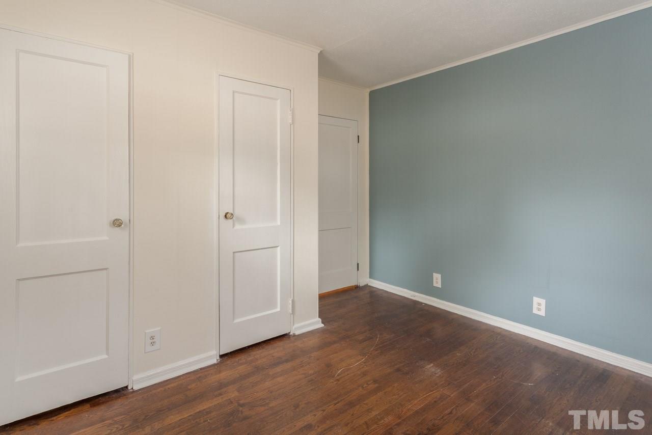 1213 Kent Road Raleigh, NC 27606 - Photo 5 of 6 a view of an empty room with wooden floor