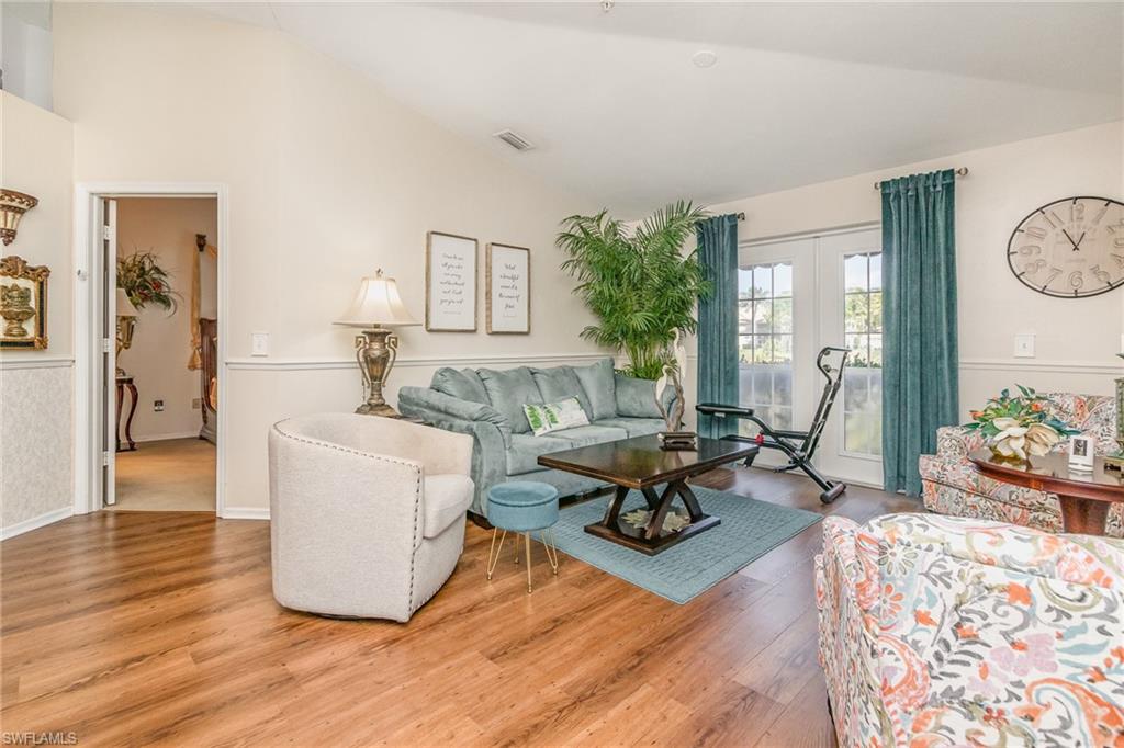 367 Dover Place, Unit 1006 Naples, FL 34104 - Photo 12 of 31 a living room with furniture and wooden floor