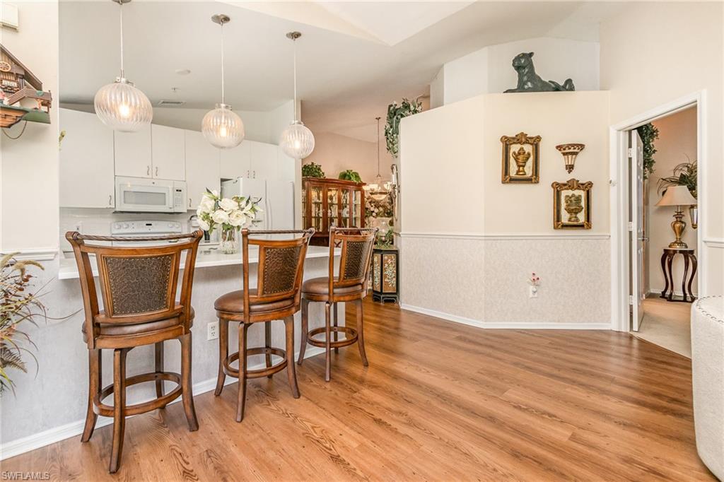 367 Dover Place, Unit 1006 Naples, FL 34104 - Photo 13 of 31 a view of a dining room with furniture and wooden floor
