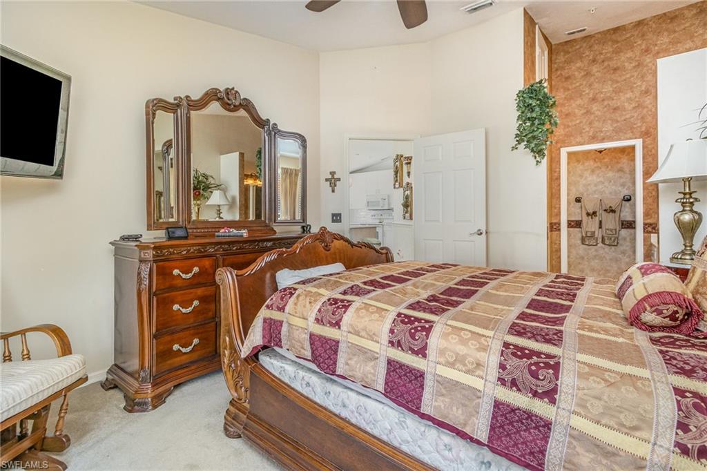 367 Dover Place, Unit 1006 Naples, FL 34104 - Photo 17 of 31 a bedroom with a bed and wooden floor
