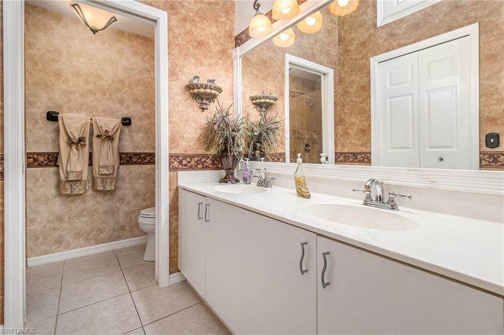 367 Dover Place, Unit 1006 Naples, FL 34104 - Photo 19 of 31 a bathroom with a sink and a mirror
