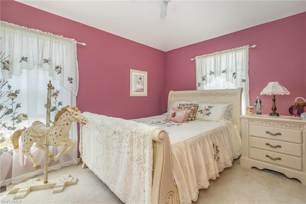 367 Dover Place, Unit 1006 Naples, FL 34104 - Photo 21 of 31 a bedroom with a bed and a window