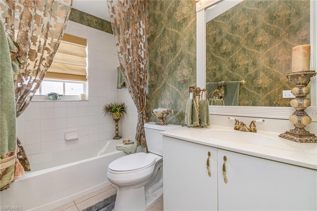 367 Dover Place, Unit 1006 Naples, FL 34104 - Photo 22 of 31 a bathroom with a sink a toilet and a bathtub
