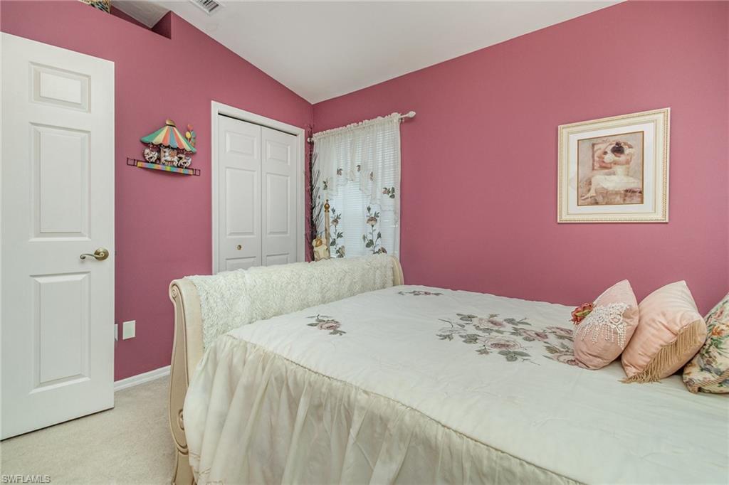 367 Dover Place, Unit 1006 Naples, FL 34104 - Photo 23 of 31 a bedroom with a bed and a painting on the wall