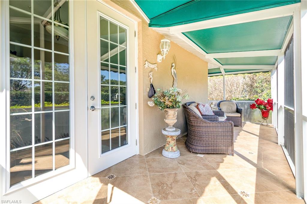 367 Dover Place, Unit 1006 Naples, FL 34104 - Photo 25 of 31 a outdoor living space with furniture and garden view