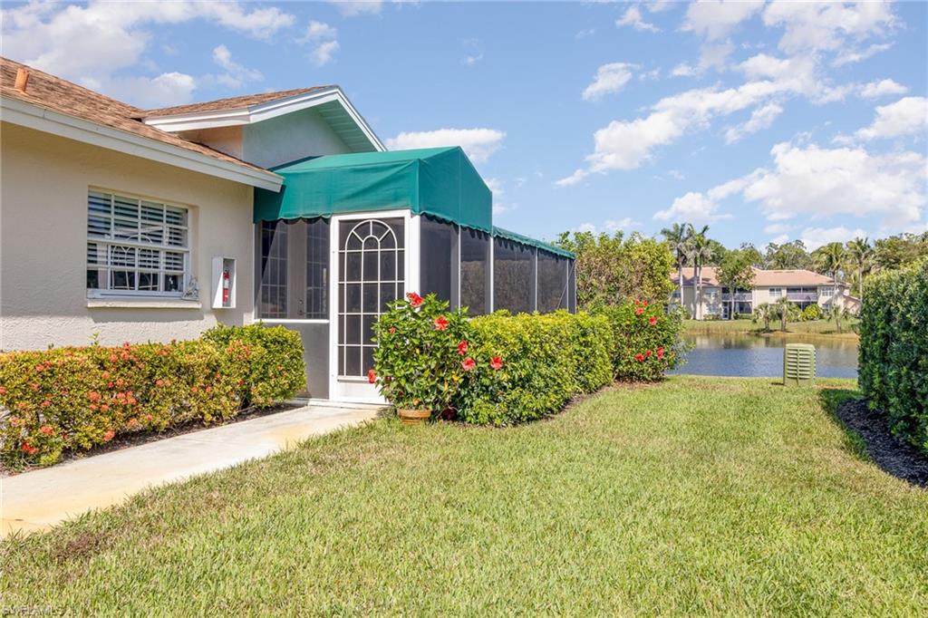 367 Dover Place, Unit 1006 Naples, FL 34104 - Photo 28 of 31 a front view of a house with garden
