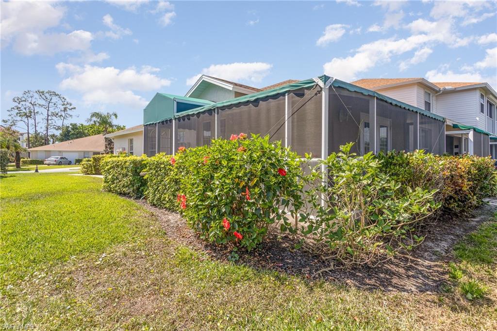 367 Dover Place, Unit 1006 Naples, FL 34104 - Photo 29 of 31 a front view of a house with garden