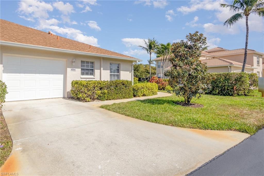 367 Dover Place, Unit 1006 Naples, FL 34104 - Photo 3 of 31 a front view of a house with garden