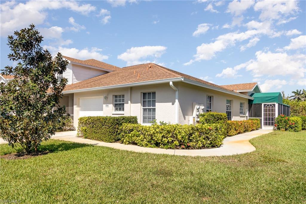 367 Dover Place, Unit 1006 Naples, FL 34104 - Photo 31 of 31 a front view of a house with a yard