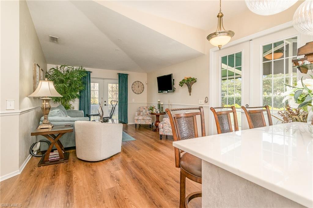 367 Dover Place, Unit 1006 Naples, FL 34104 - Photo 4 of 31 a living room with furniture a flat screen tv and a table