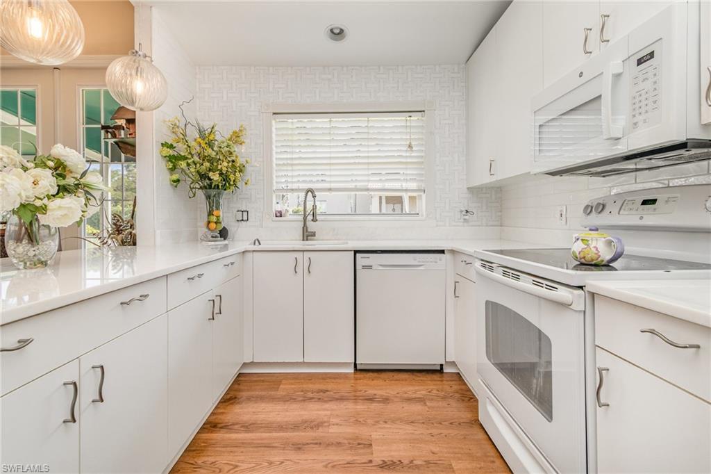 367 Dover Place, Unit 1006 Naples, FL 34104 - Photo 5 of 31 a kitchen with a sink cabinets and window