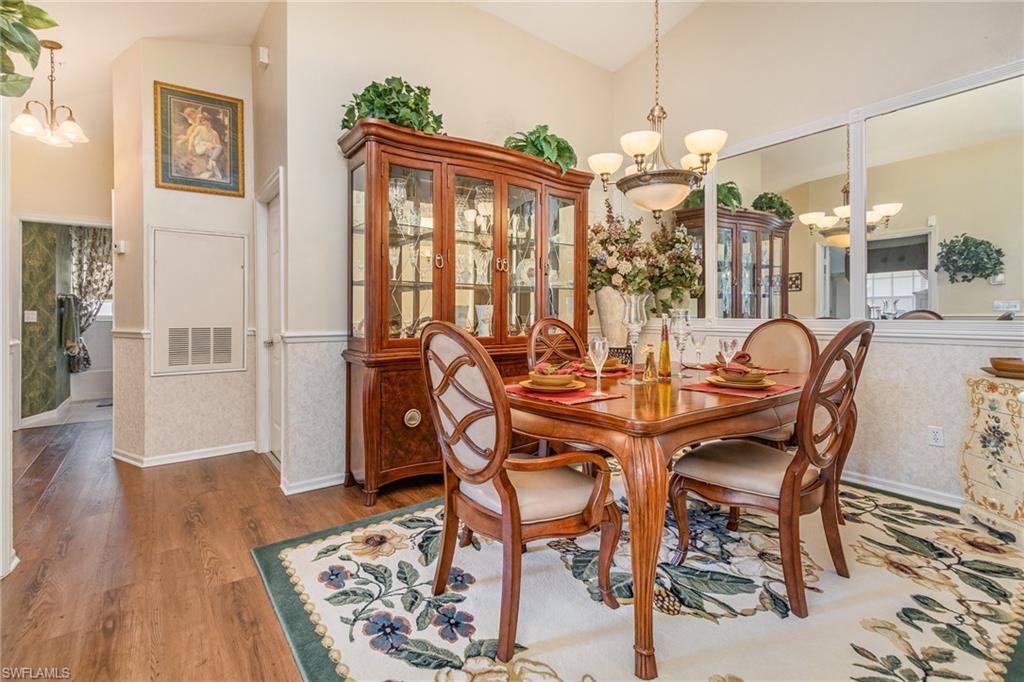 367 Dover Place, Unit 1006 Naples, FL 34104 - Photo 9 of 31 a view of a dining room with furniture window and wooden floor