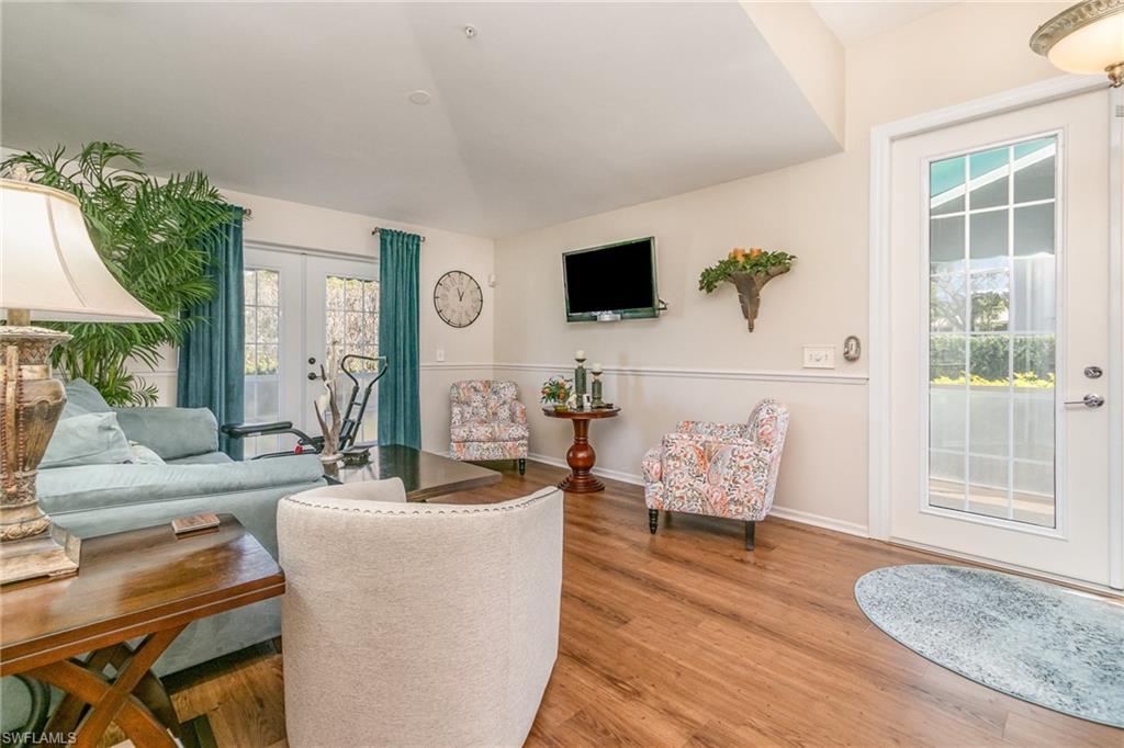 367 Dover Place, Unit 1006 Naples, FL 34104 - Photo 10 of 31 a living room with furniture and a flat screen tv