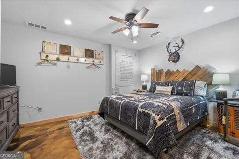 a bedroom with a large bed and a chandelier