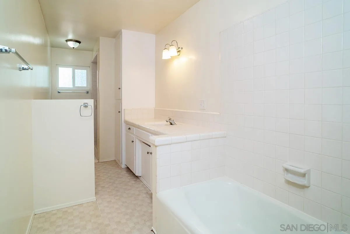6777 West Lilac Road Bonsall, CA 92003 - Photo 23 of 36 a bathroom with a sink a mirror and a bathtub