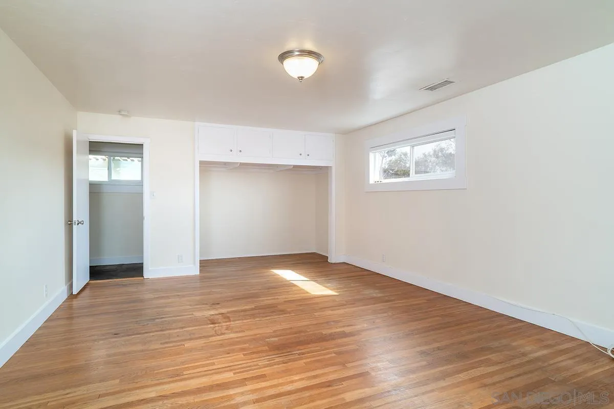 6777 West Lilac Road Bonsall, CA 92003 - Photo 27 of 36 a view of an empty room with wooden floor