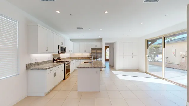 a kitchen with a sink a counter top and outdoor space
