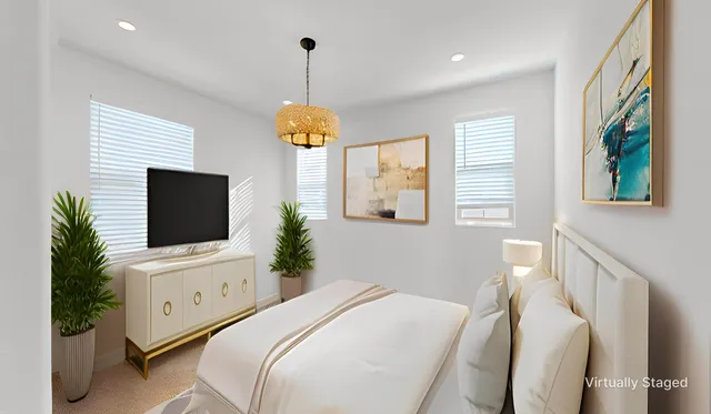 a bedroom with a bed and a potted plant