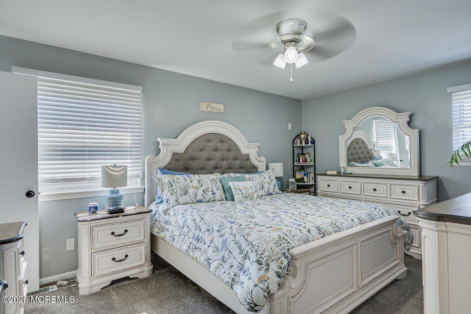 11 Quailtree Lane Howell, NJ 07731 - Photo 28 of 52 a bedroom with a bed and a chandelier