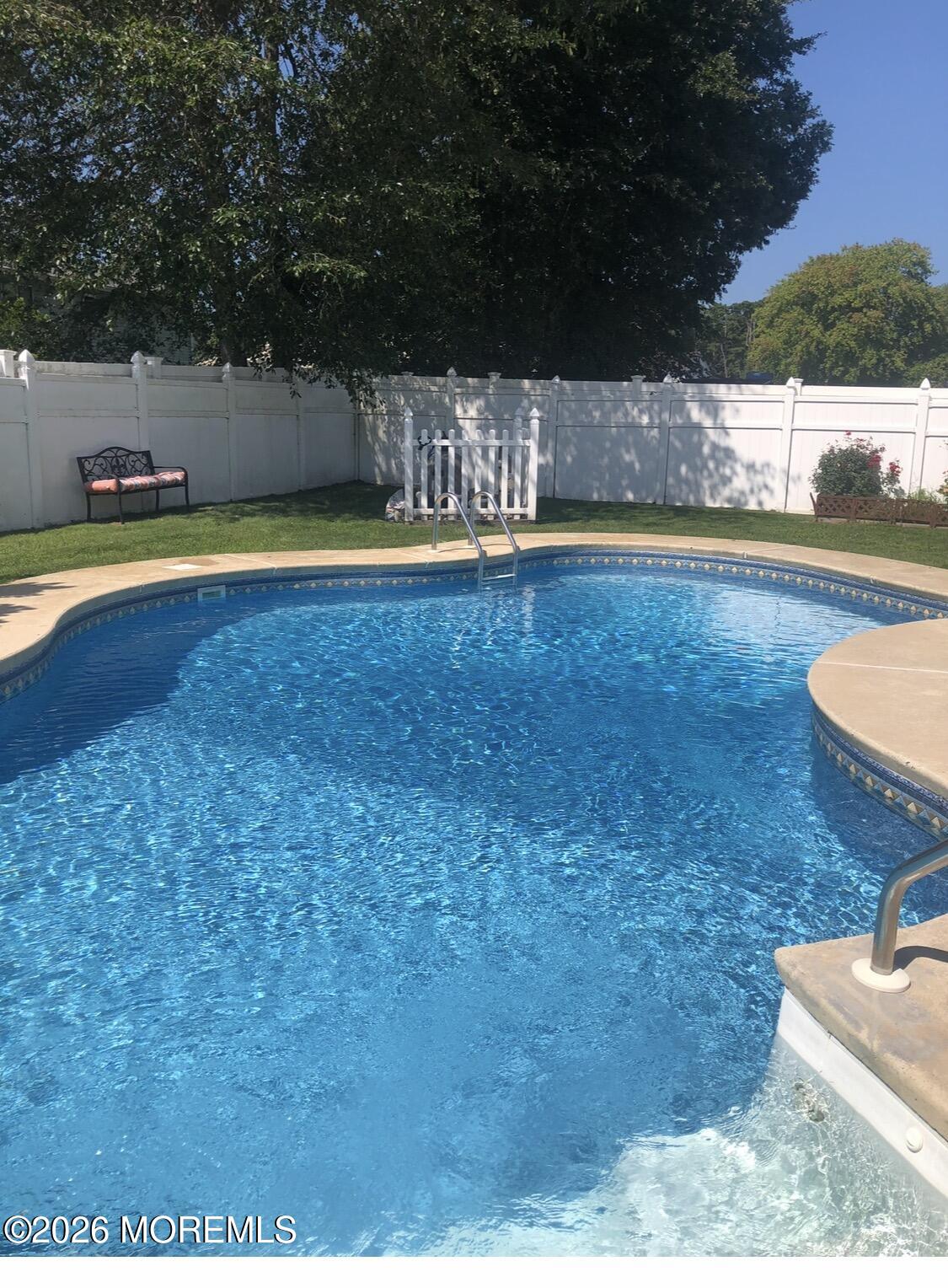 11 Quailtree Lane Howell, NJ 07731 - Photo 41 of 52 a view of a swimming pool with an outdoor space and seating area