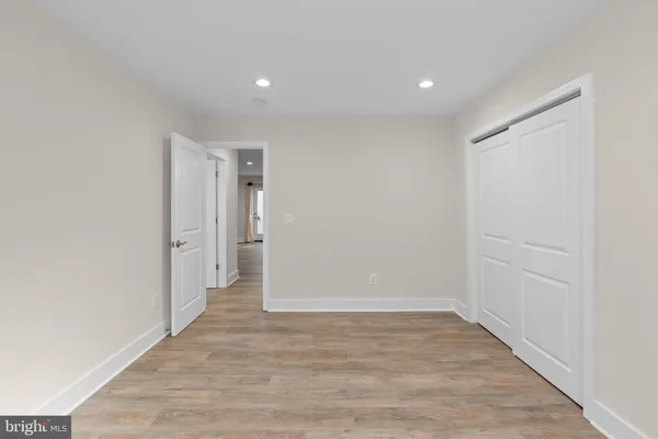 a view of hallway with wooden floor