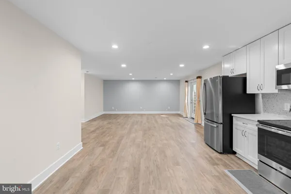 a view of kitchen with refrigerator microwave and stove