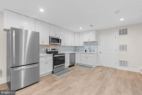 a kitchen with a refrigerator stove and microwave