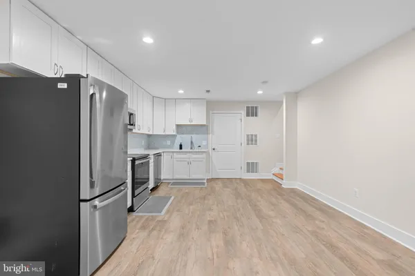 a kitchen with stainless steel appliances a refrigerator and a stove top oven