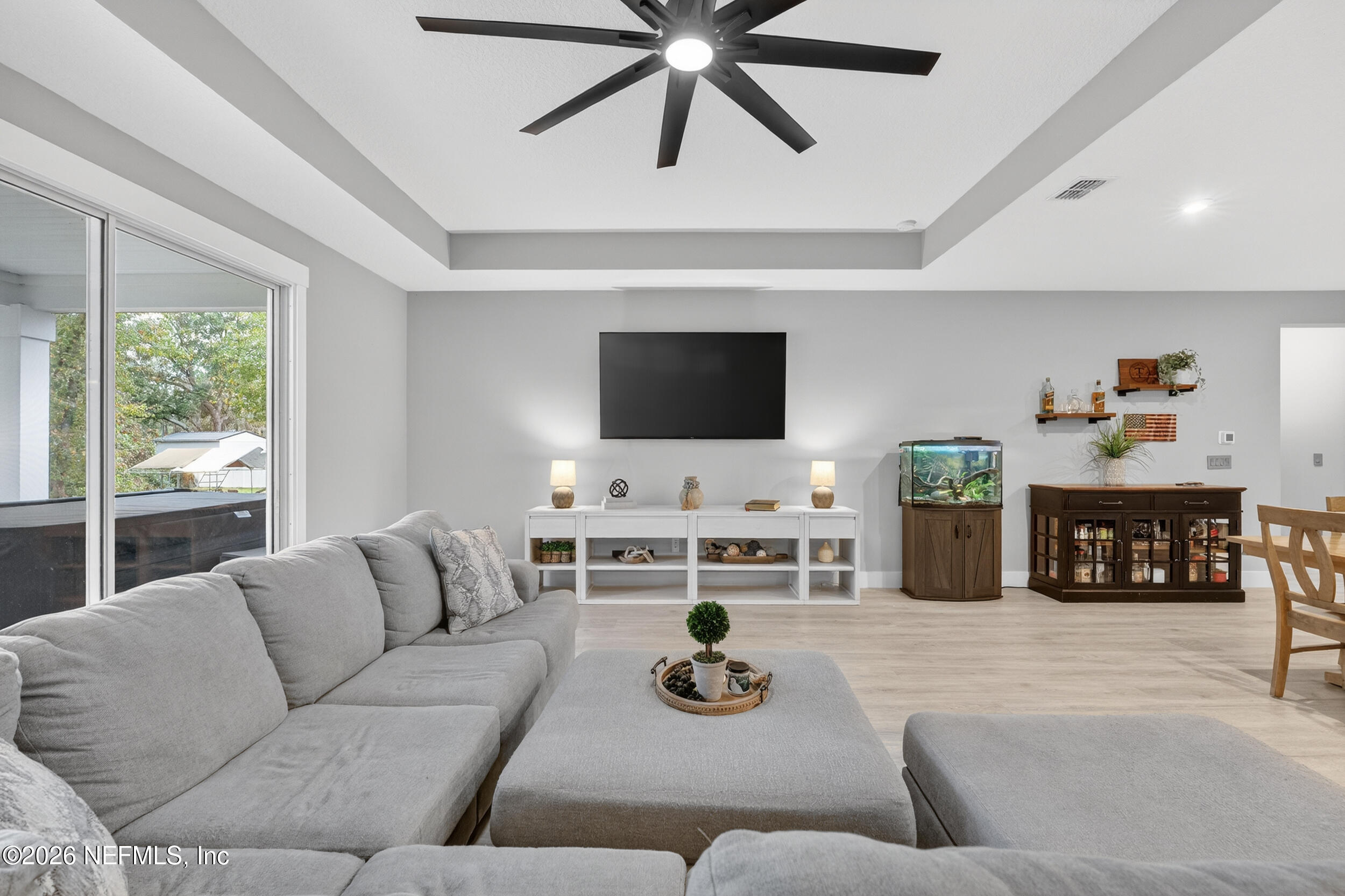 4028 Little Bit Court Middleburg, FL 32068 - Photo 17 of 47 a living room with furniture and a flat screen tv with wooden floor