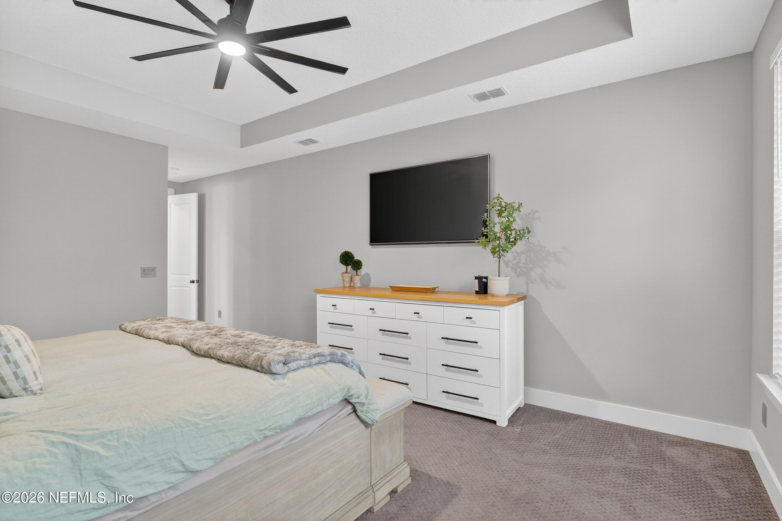 4028 Little Bit Court Middleburg, FL 32068 - Photo 23 of 47 a bedroom with a bed and a flat screen tv