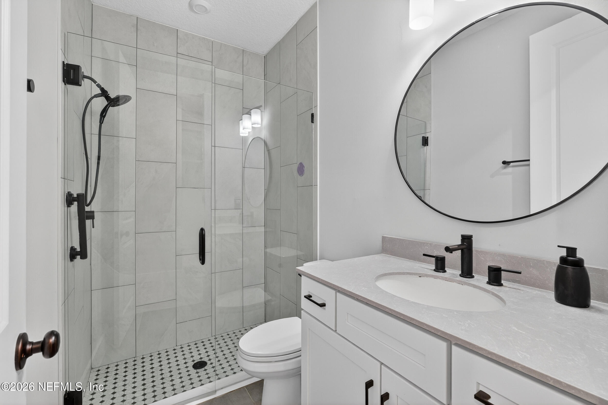 4028 Little Bit Court Middleburg, FL 32068 - Photo 32 of 47 a bathroom with a sink toilet and shower