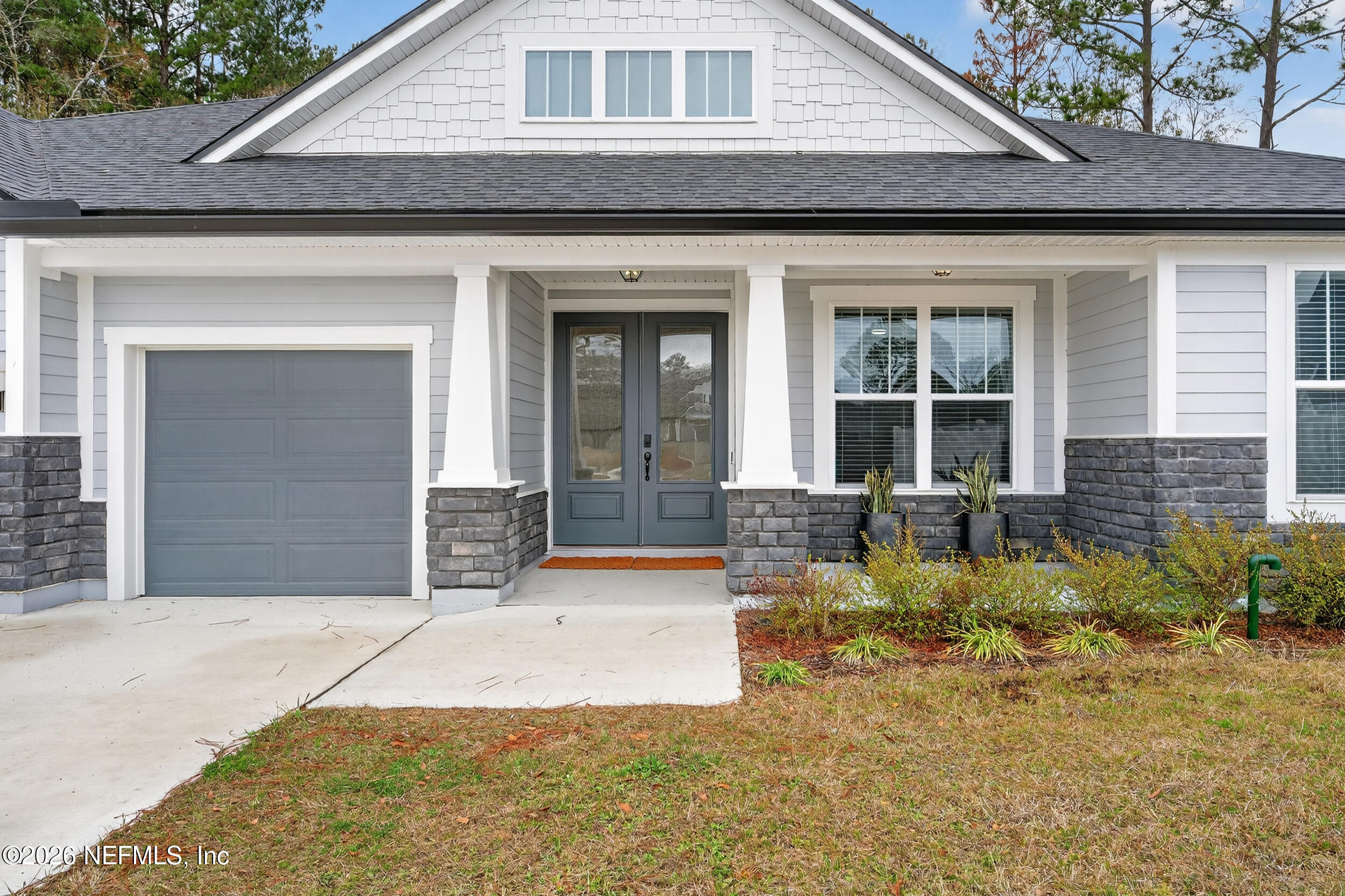 4028 Little Bit Court Middleburg, FL 32068 - Photo 4 of 47 a front view of a house with garden
