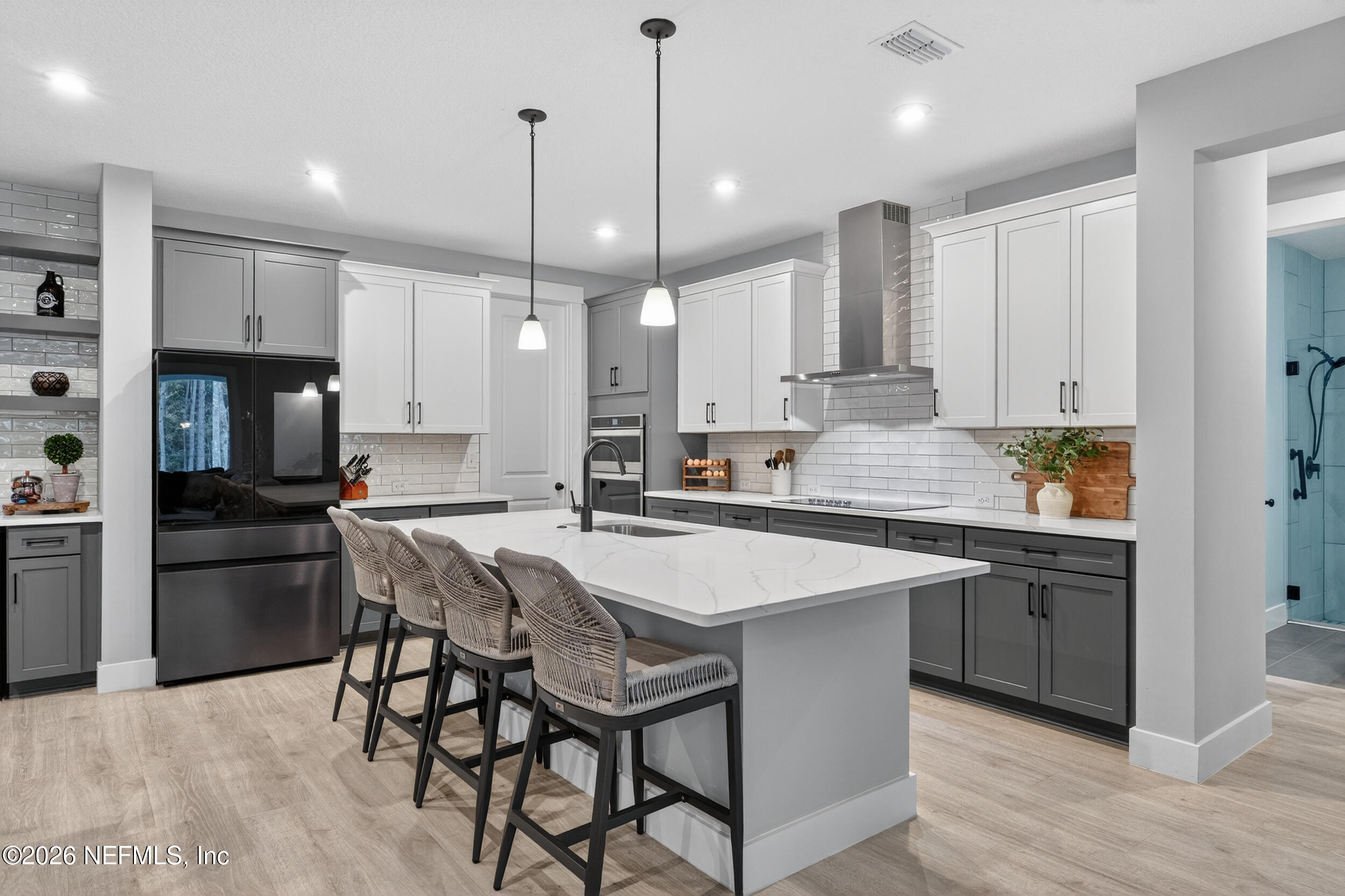 4028 Little Bit Court Middleburg, FL 32068 - Photo 10 of 47 a kitchen with stainless steel appliances granite countertop a sink a stove a refrigerator and island with wooden floor