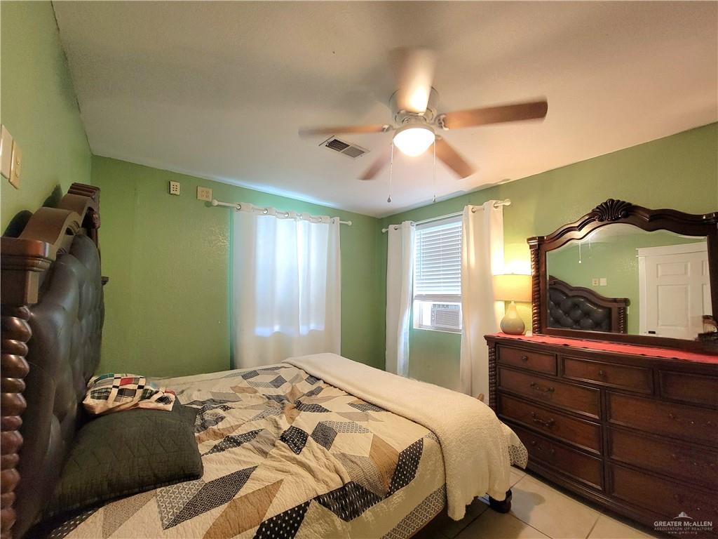 206 South Arroyo Boulevard Rio Hondo, TX 78583 - Photo 13 of 42 5th bedroom ( On the 1st floor) Bedroom with ceiling fan and tile patterned flooring