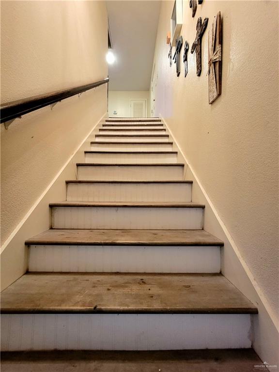 206 South Arroyo Boulevard Rio Hondo, TX 78583 - Photo 17 of 42 Staircase with a textured wall