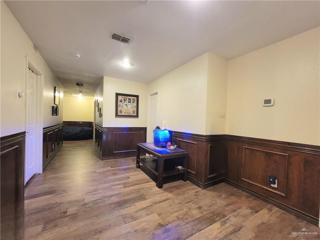 206 South Arroyo Boulevard Rio Hondo, TX 78583 - Photo 18 of 42 Hall with wainscoting and dark wood finished floors