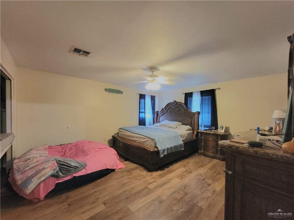 206 South Arroyo Boulevard Rio Hondo, TX 78583 - Photo 21 of 42 1st Bedroom with a ceiling fan and light wood finished floors