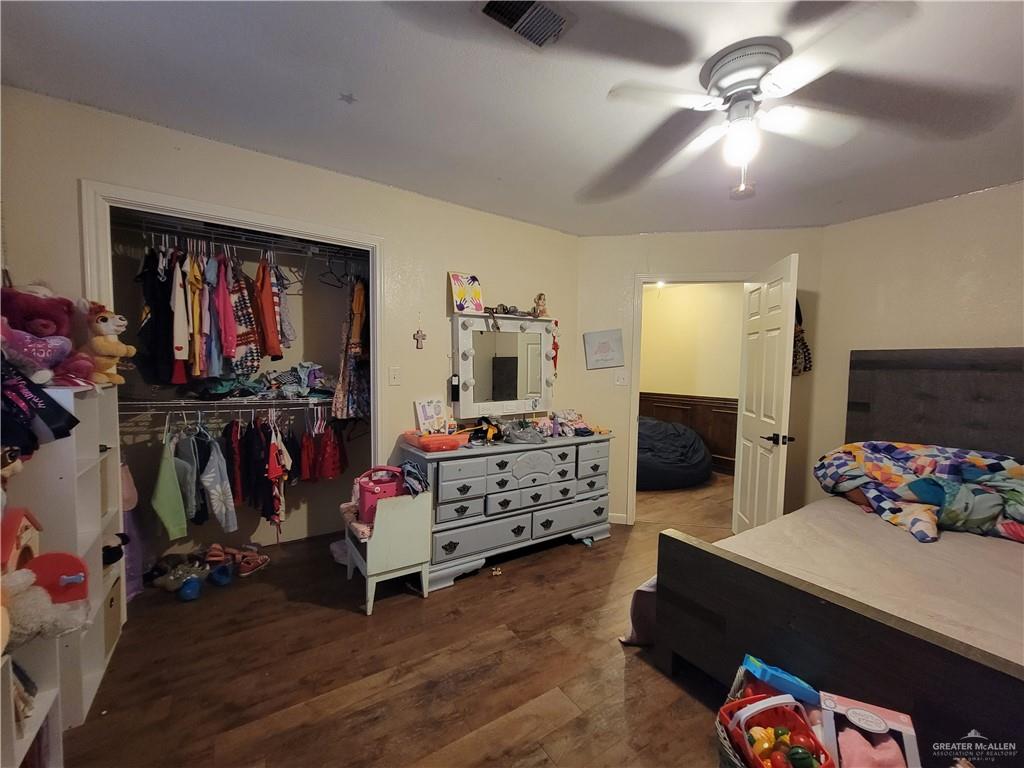 206 South Arroyo Boulevard Rio Hondo, TX 78583 - Photo 27 of 42 4th Bedroom featuring dark wood-type flooring, a ceiling fan, and a closet