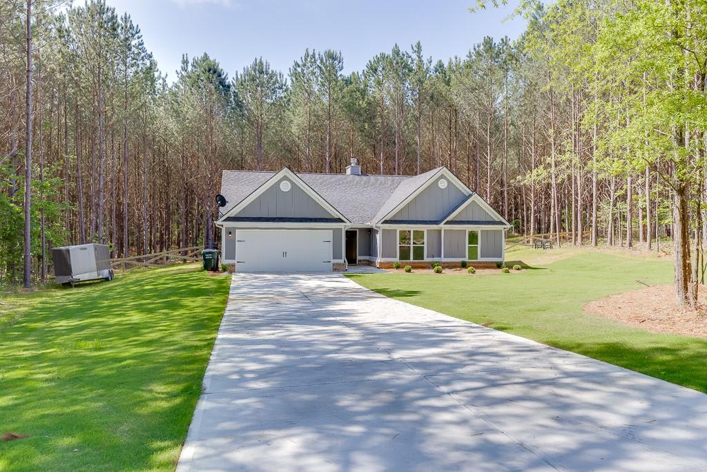 a front view of house with yard and green space