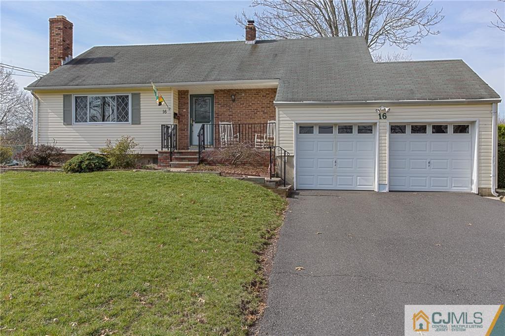 16 Fulton Road Somerset, NJ 08873 - Photo 1 of 25 a front view of a house with a garden and yard