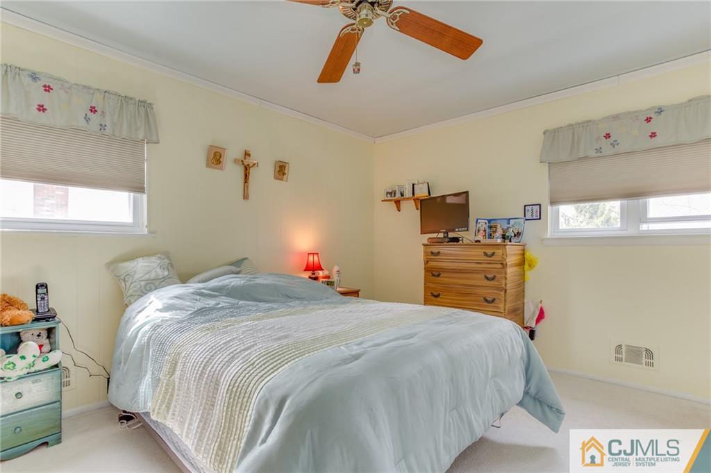 16 Fulton Road Somerset, NJ 08873 - Photo 13 of 25 a bed sitting in a bedroom next to a window