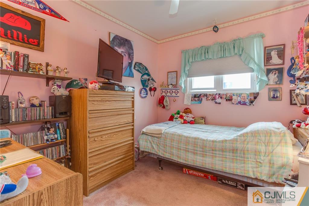 16 Fulton Road Somerset, NJ 08873 - Photo 15 of 25 a bedroom with a bed and a mirror