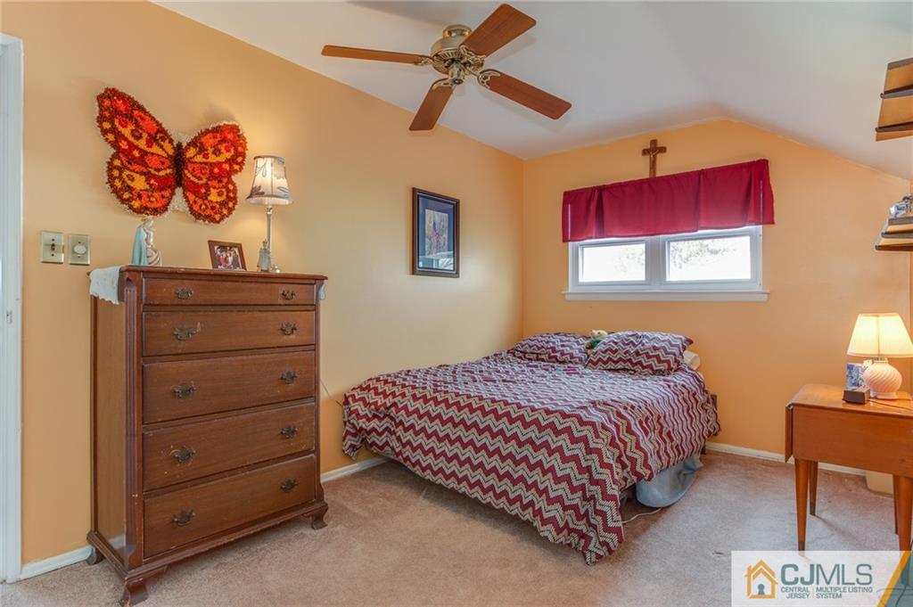 16 Fulton Road Somerset, NJ 08873 - Photo 16 of 25 a bedroom with a bed and a chandelier