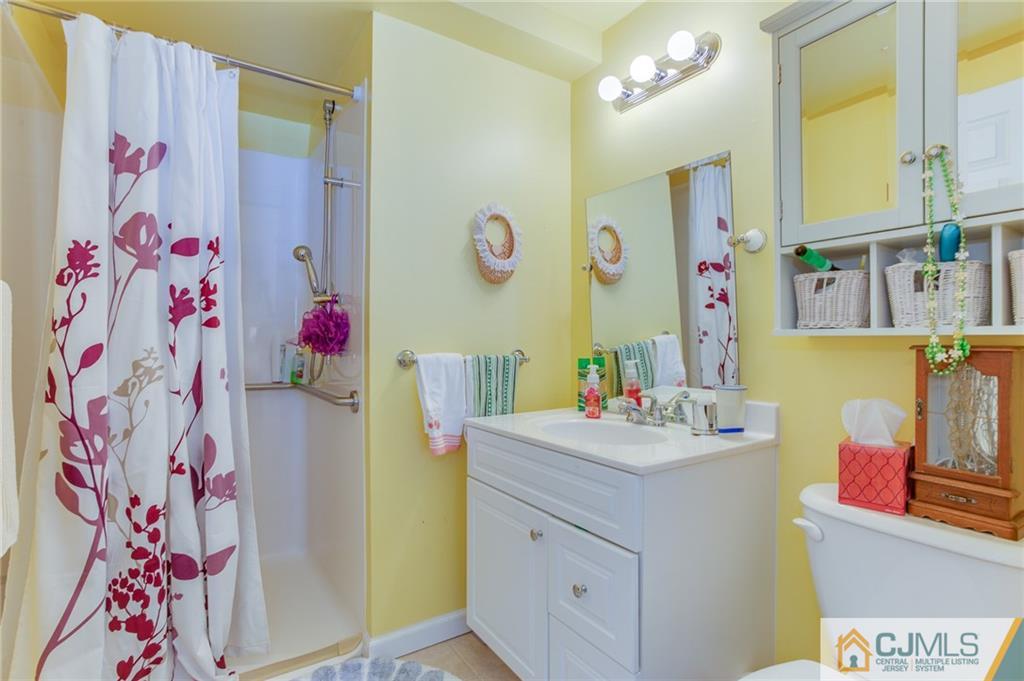 16 Fulton Road Somerset, NJ 08873 - Photo 19 of 25 a bathroom with a sink mirror and vanity